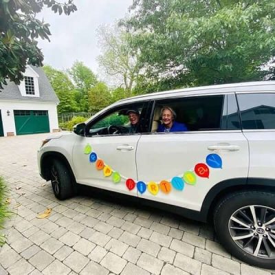Tom and THS Vice President Cathy Hill do a drive-by birthday greeting.